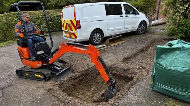 Engineers excavating ground to install new underground PVC drainage pipes.